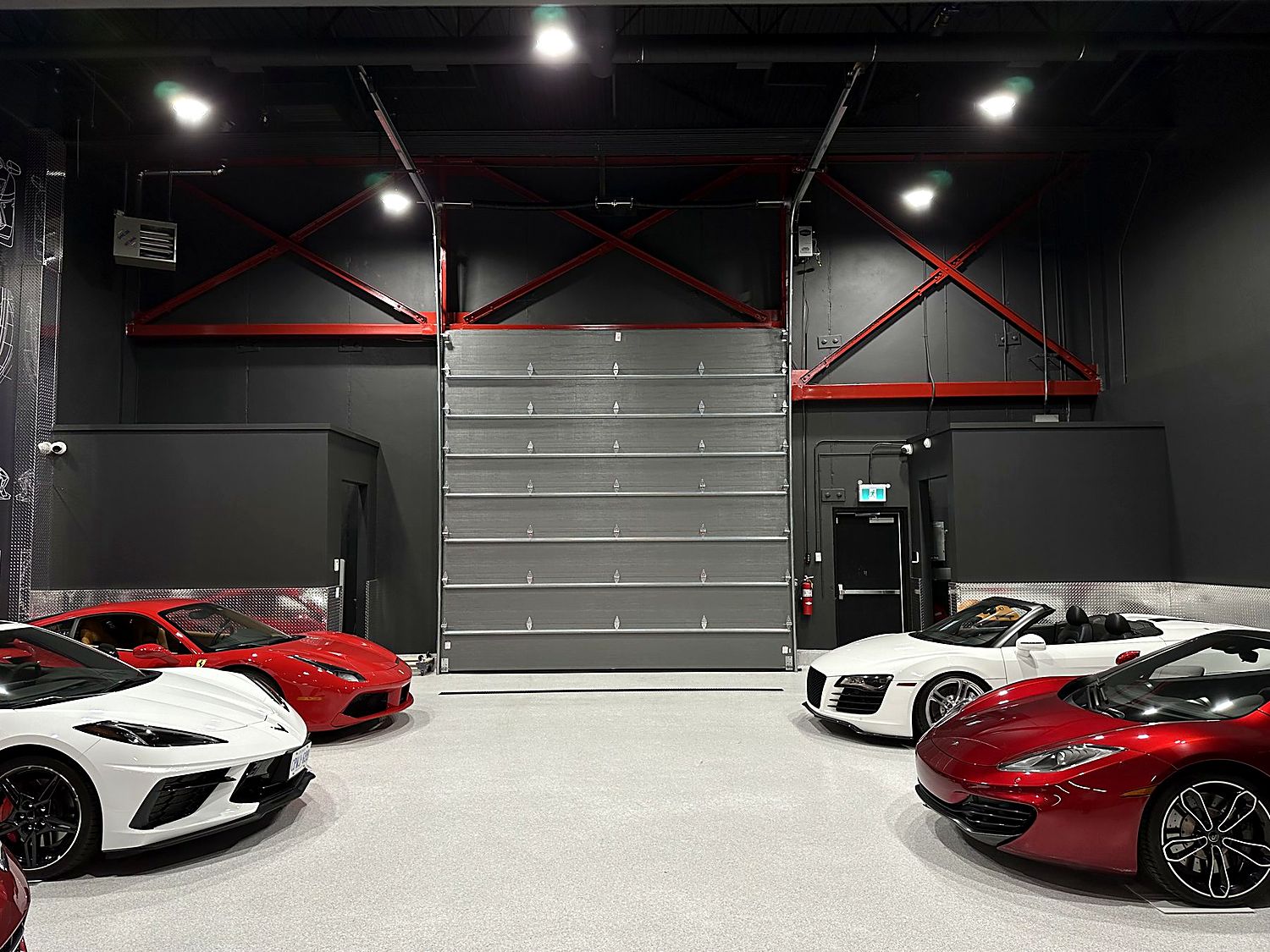 Open commercial interior with dark spray-finished exposed ceiling