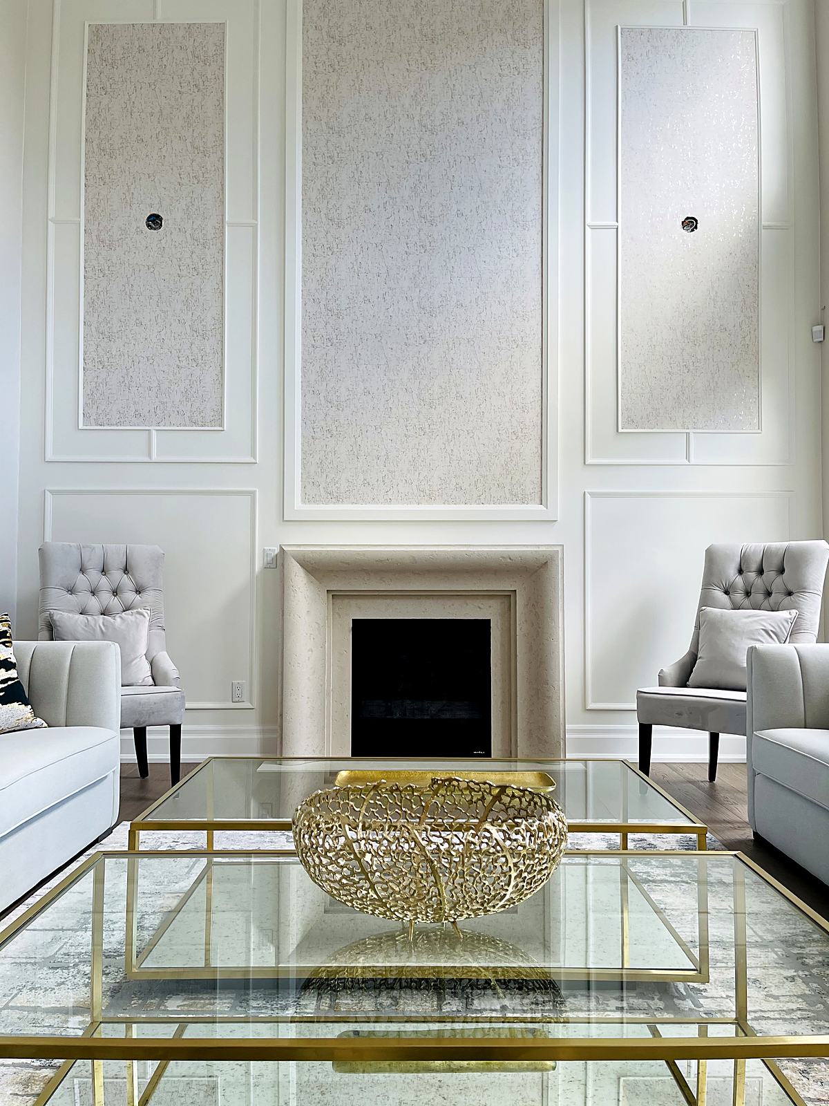Living room fireplace wall with painted panelling and textured wallpaper inserts